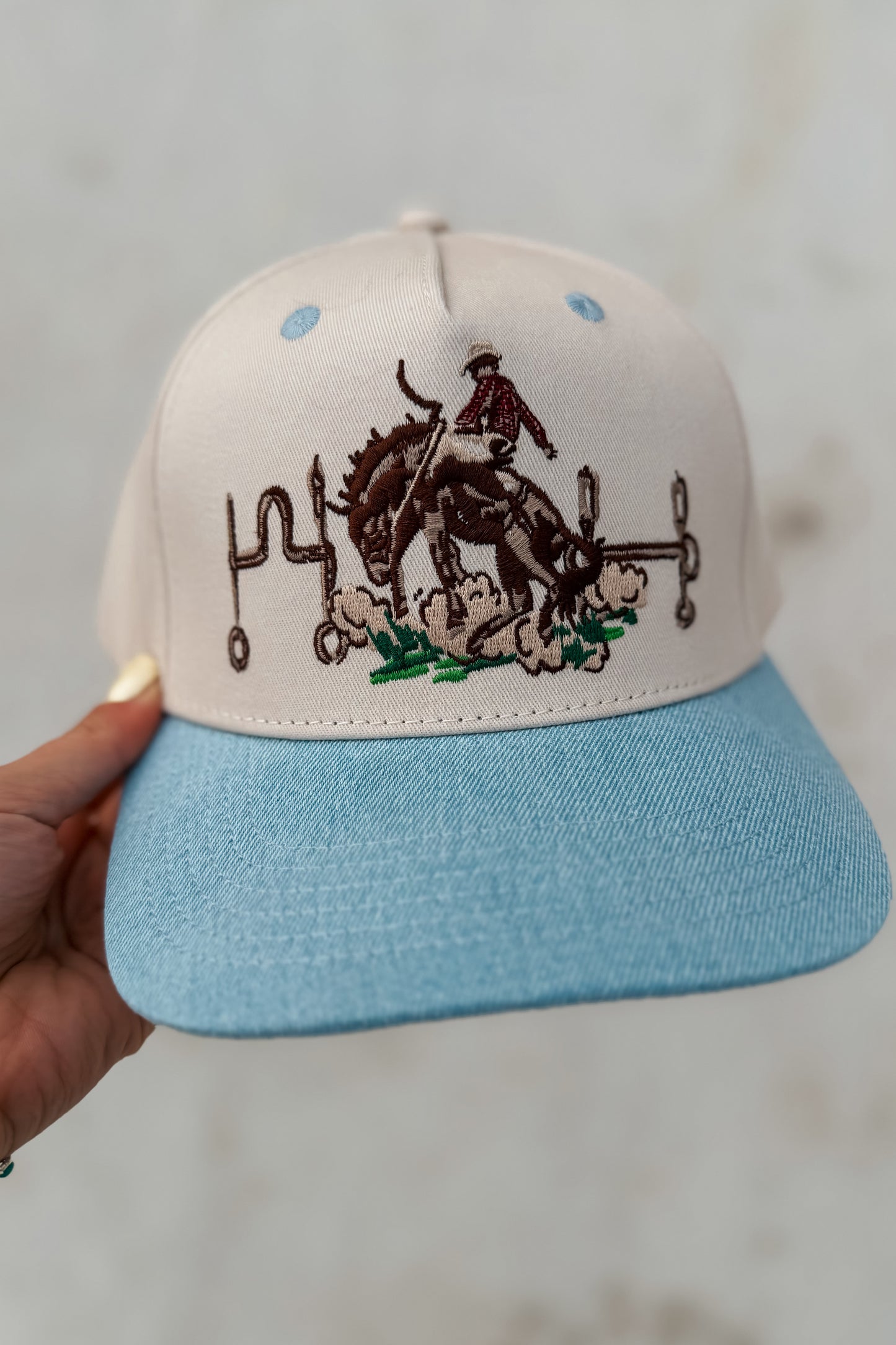 Snapback with a horse and rider design.