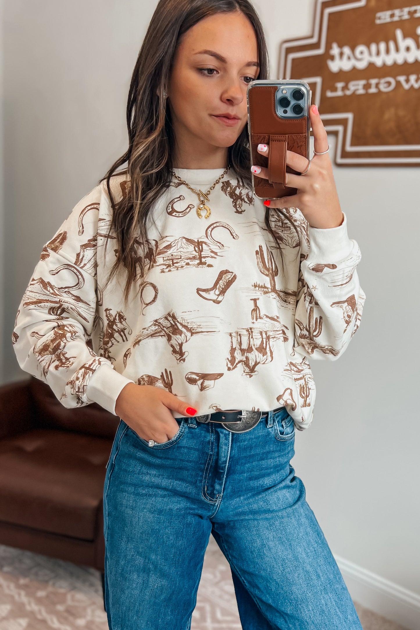 Cream long-sleeve sweatshirt paired with jeans.