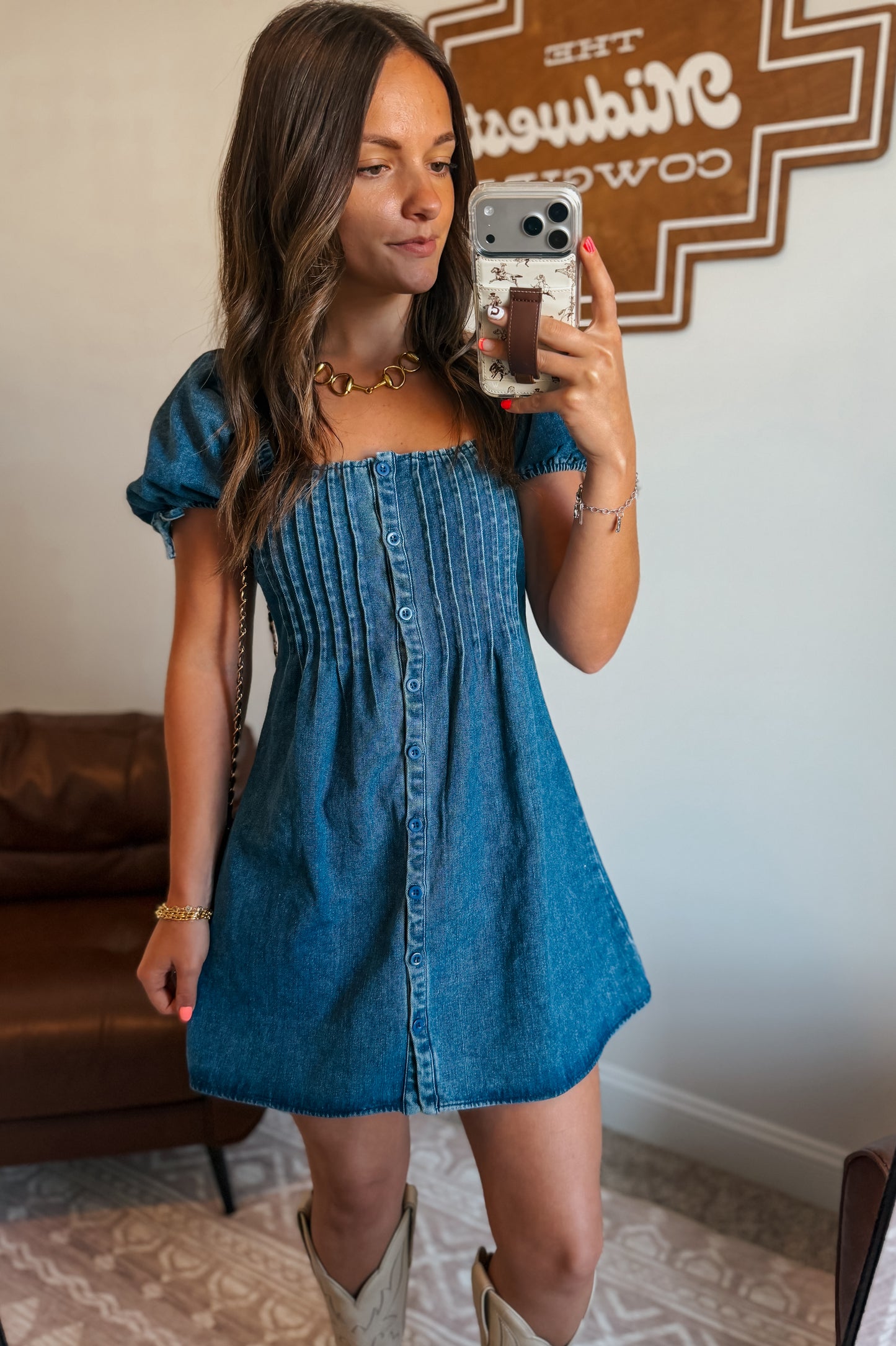 Front view of denim mini dress with square neckline and puff sleeves.