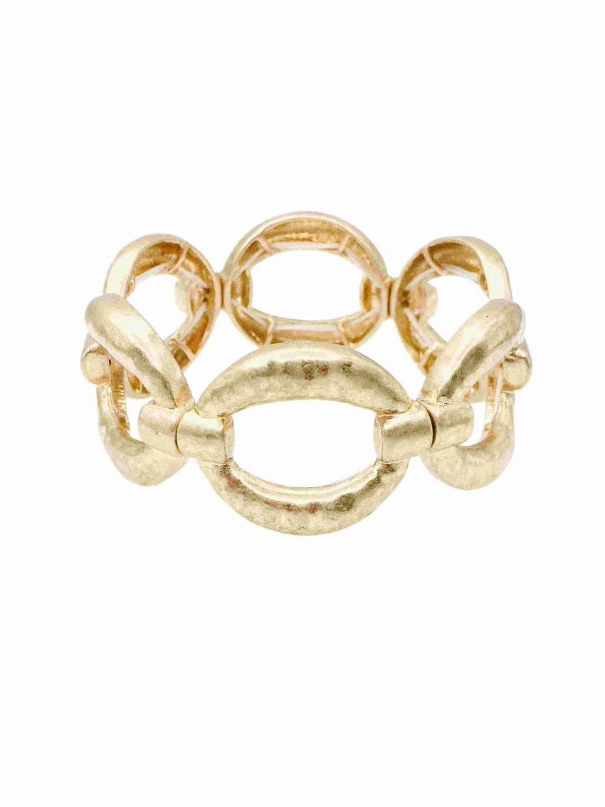 Gold ring with interlocking design on a white background
