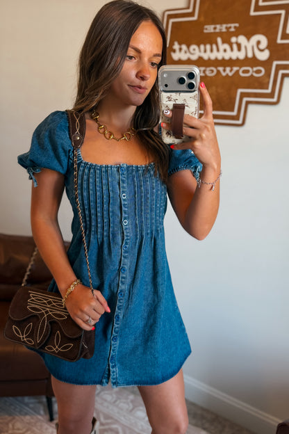 Front view of denim mini dress with square neckline and puff sleeves.