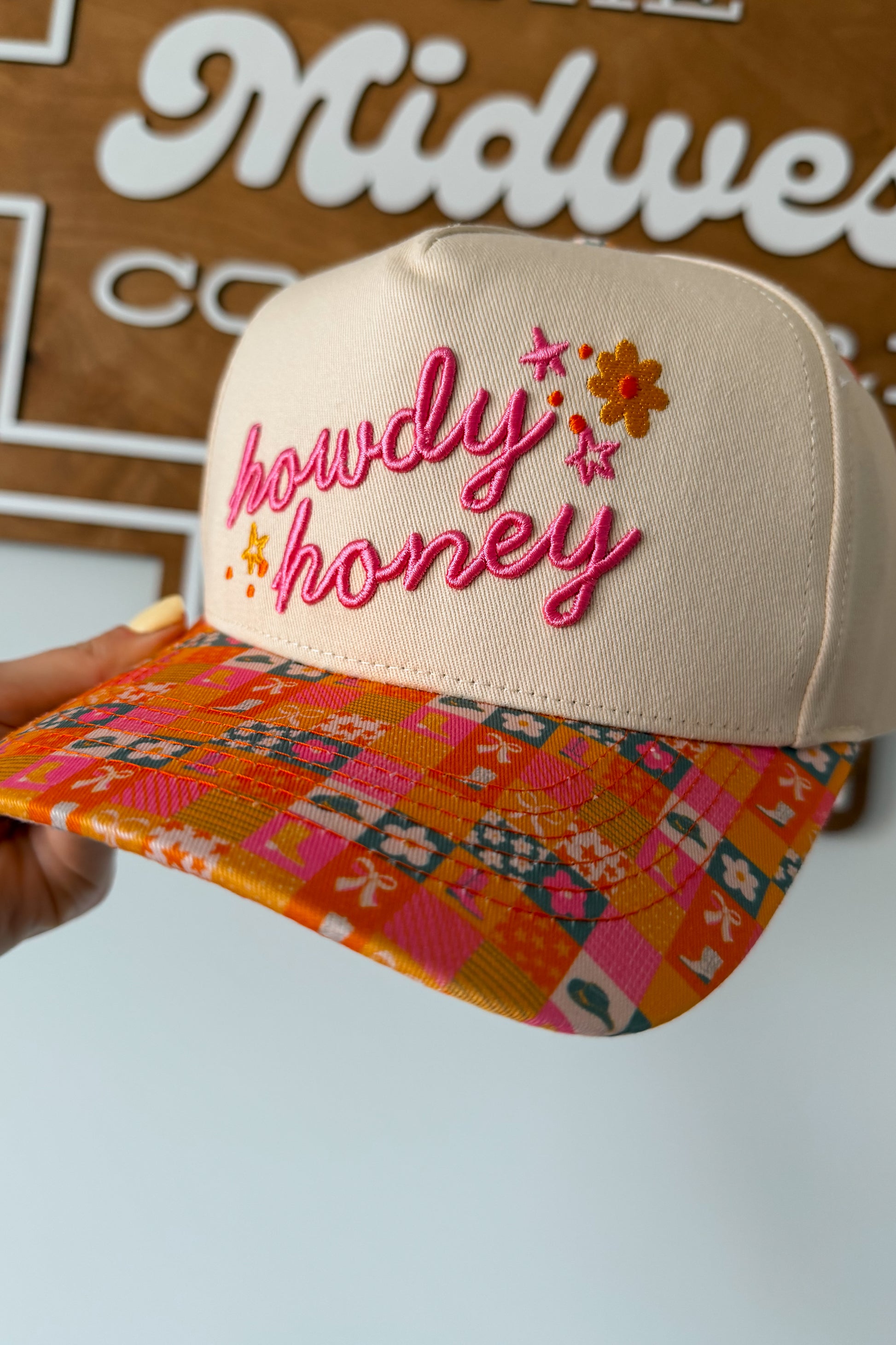 Pink and orange canvas cap with ‘Howdy Honey’ text on the front and a checkered pattern on the brim, casual Western-inspired accessory