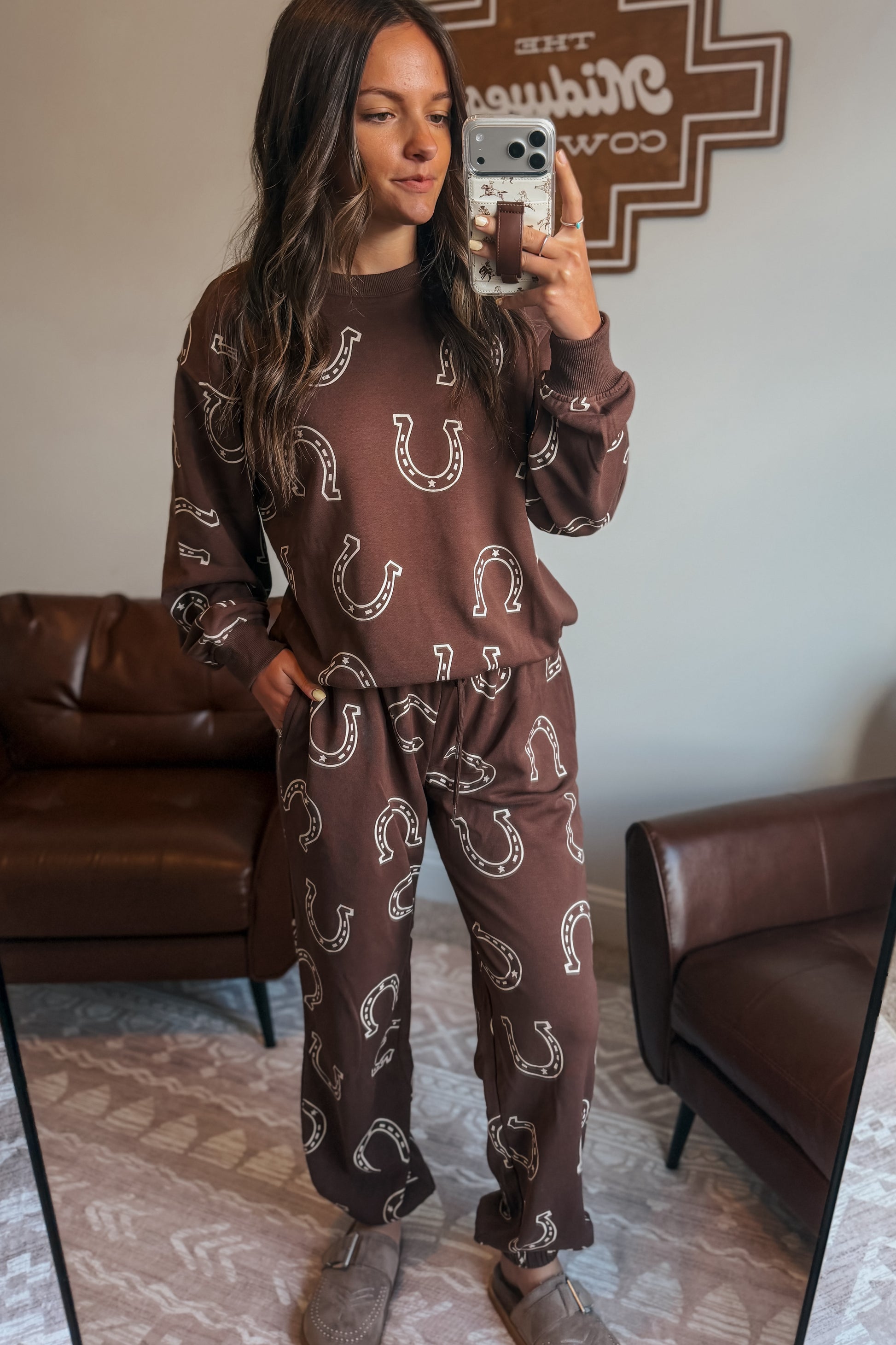 Brown two-piece jogger set with white horseshoe pattern, including long-sleeve sweatshirt and jogger-style pants.