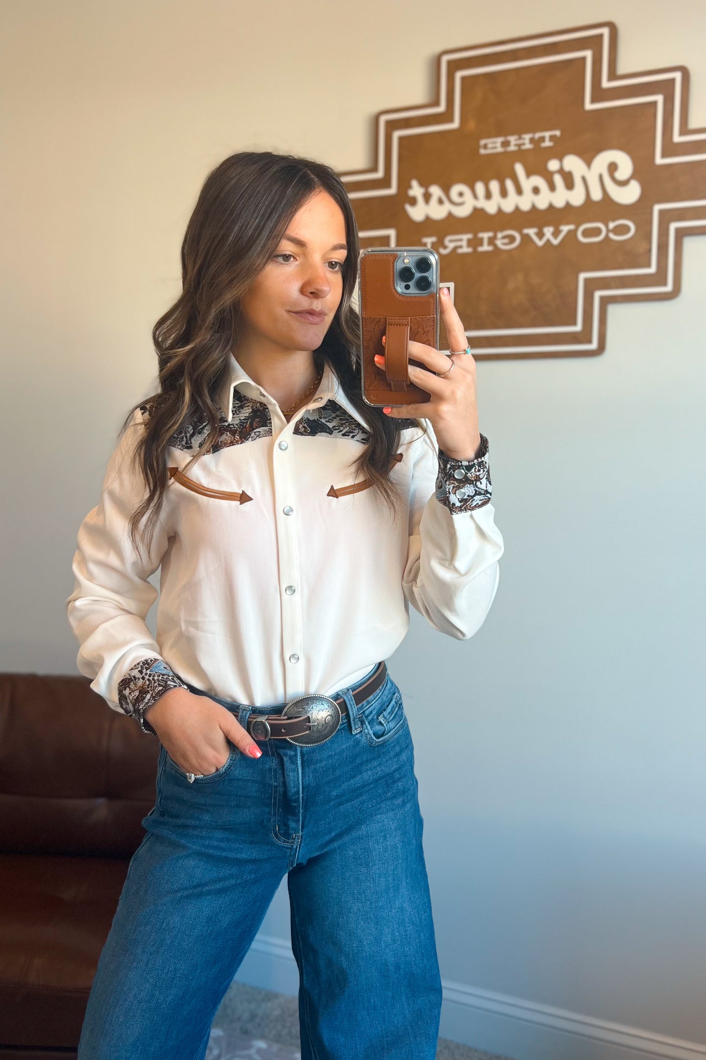 White long sleeve western snap button shirt with contrast southwestern print yoke across the shoulders and matching printed cuffs.