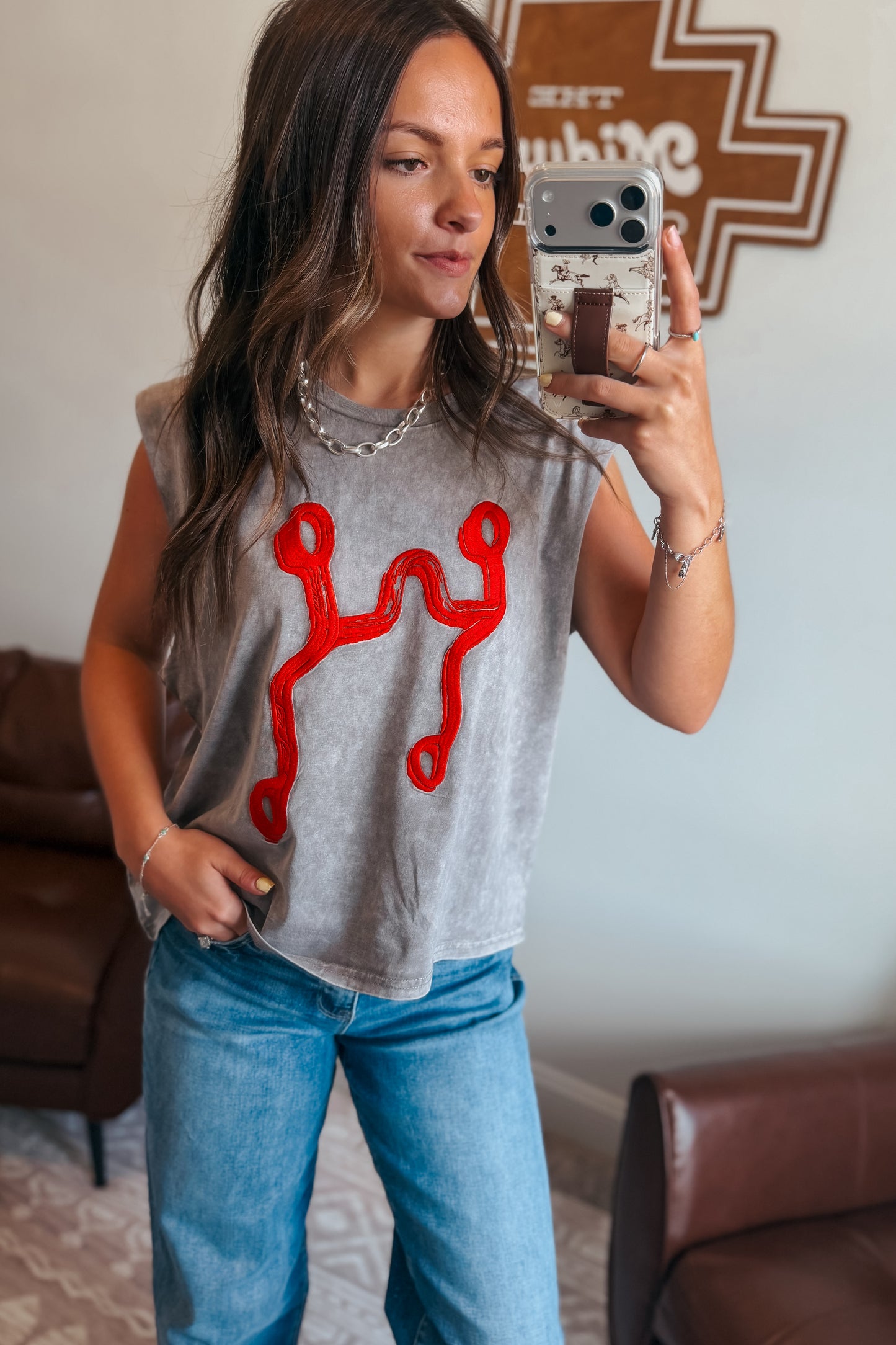 Front view of gray mineral wash muscle tank top with red curb bit embroidery.