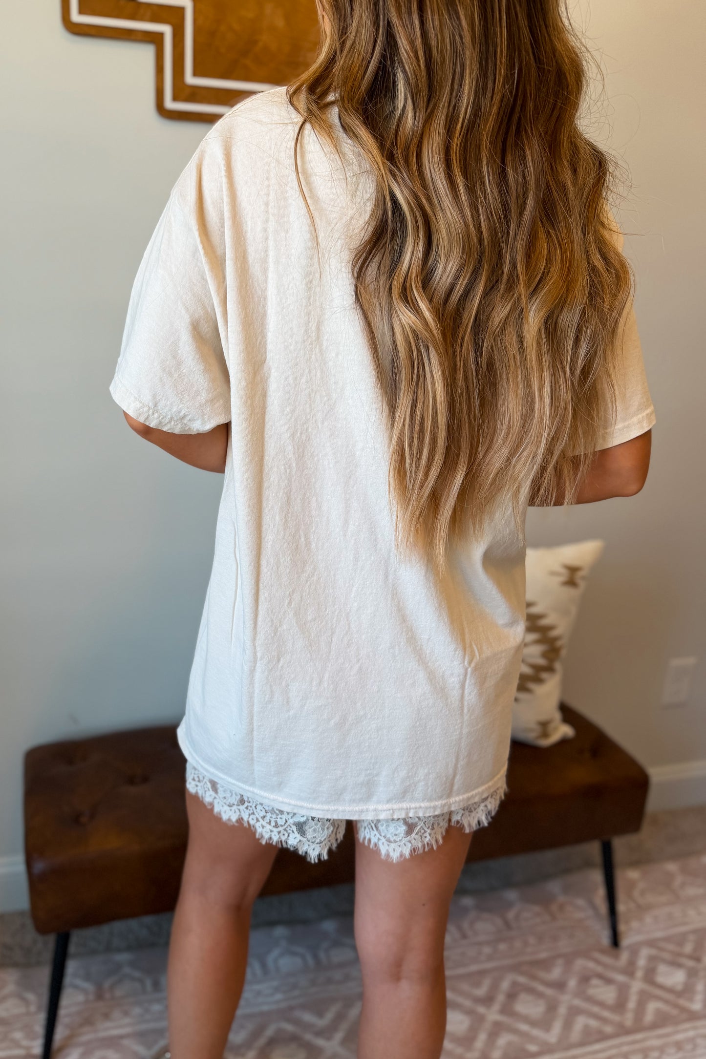 Back view of a cream oversized graphic tee with a loose, comfortable silh