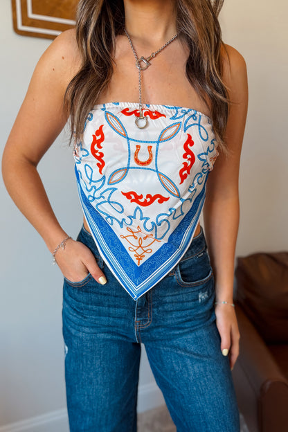 Model wearing a white strapless tube top with blue western print.
