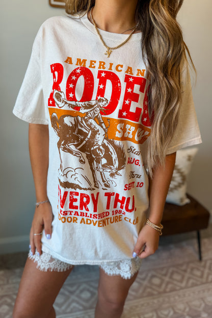 Cream oversized graphic tee featuring an American rodeo-inspired design on the front.