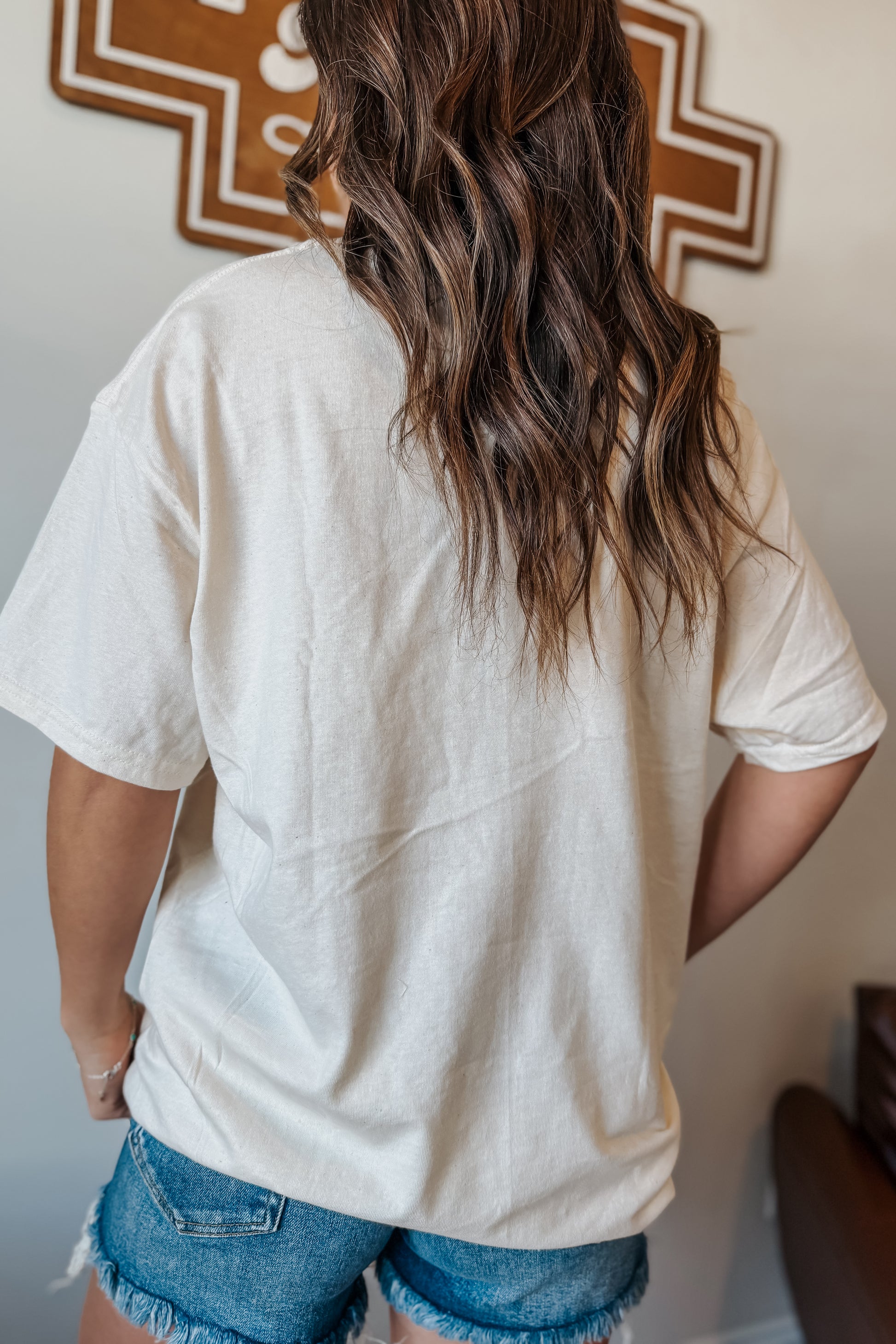 Back view of a cream oversized t-shirt,