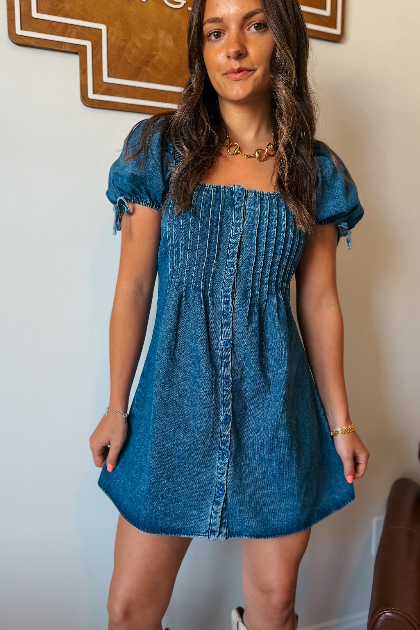 Front view of denim mini dress with square neckline and puff sleeves.