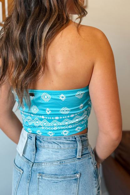 Back view of vibrant turquoise tube top with bandanna print.