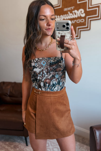 Western tapestry print corset top with adjustable straps paired with camel color skort