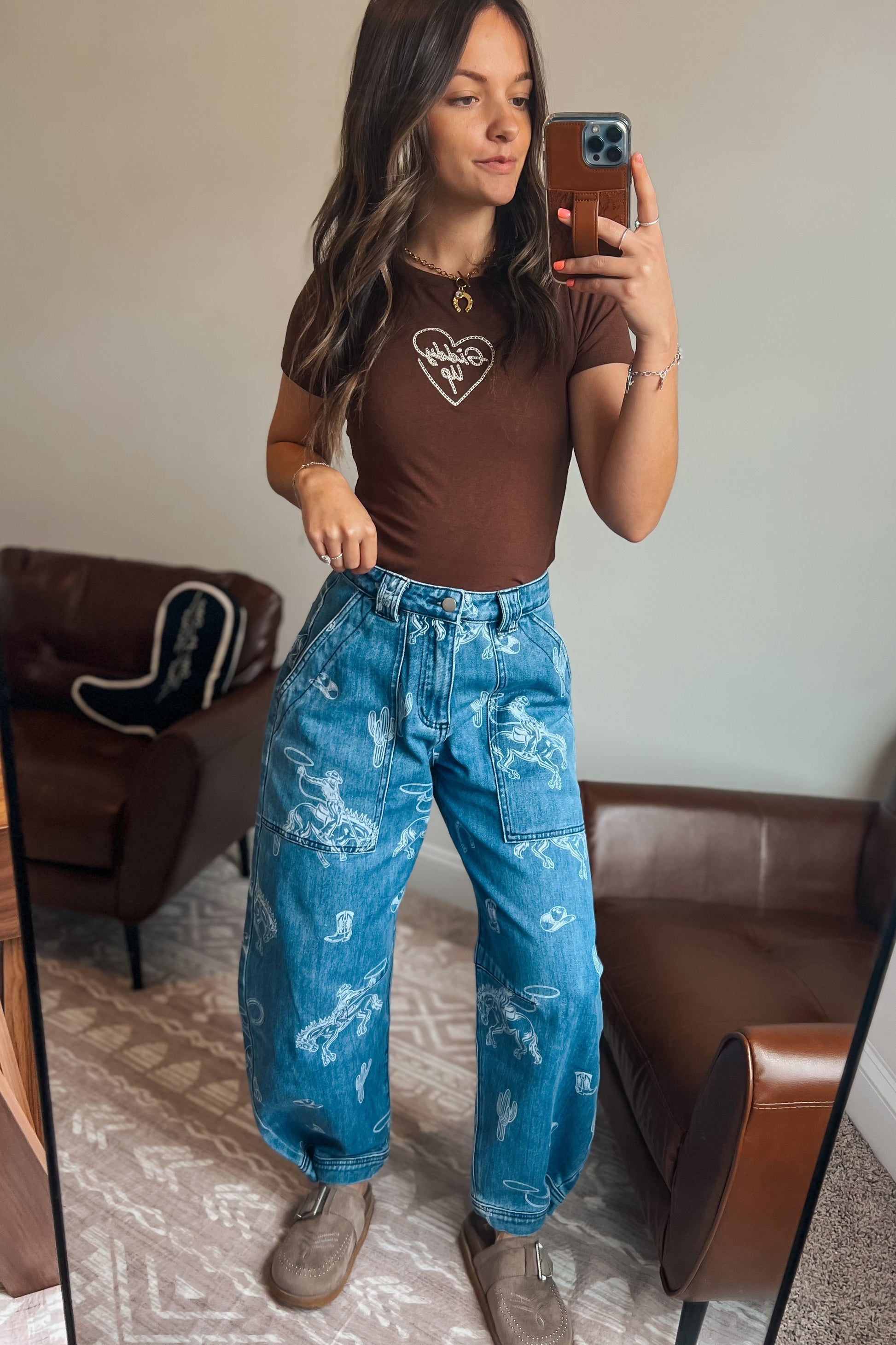 Western-inspired printed denim jeans with cowboy and rodeo motifs