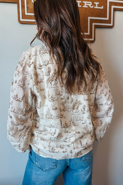 Back view of cream and brown western print long sleeve blouse with long sleeves and relaxed fit.