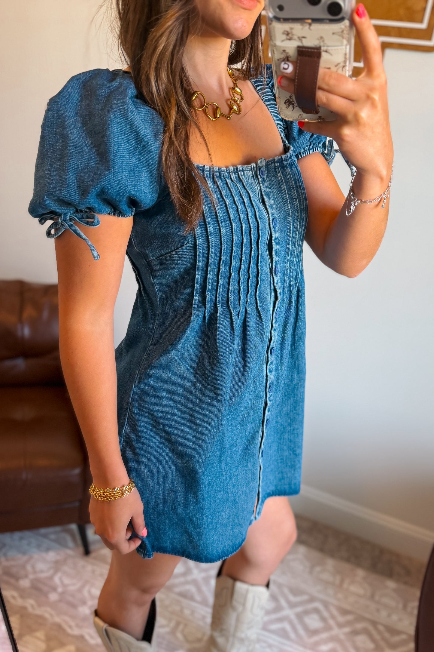 Side view of denim mini dress with square neckline and puff sleeves.