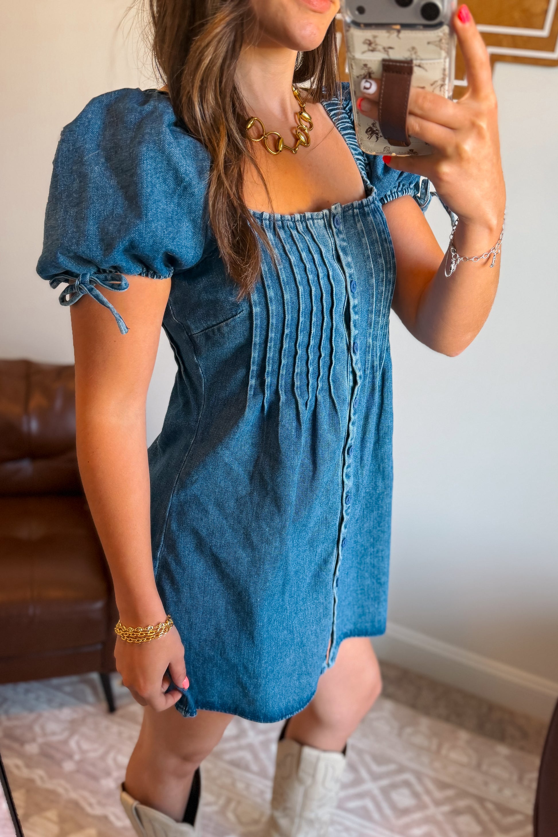Side view of denim mini dress with square neckline and puff sleeves.