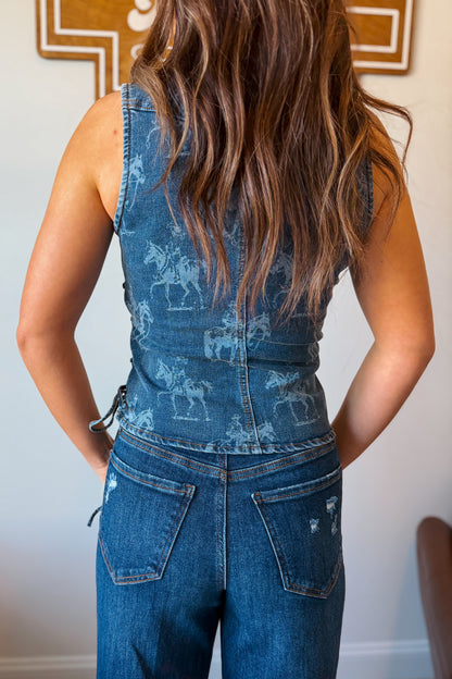 Back view of denim vest with western print detail.