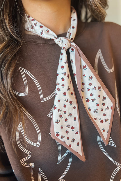 Close-up of western floral print bandana tied at the neck