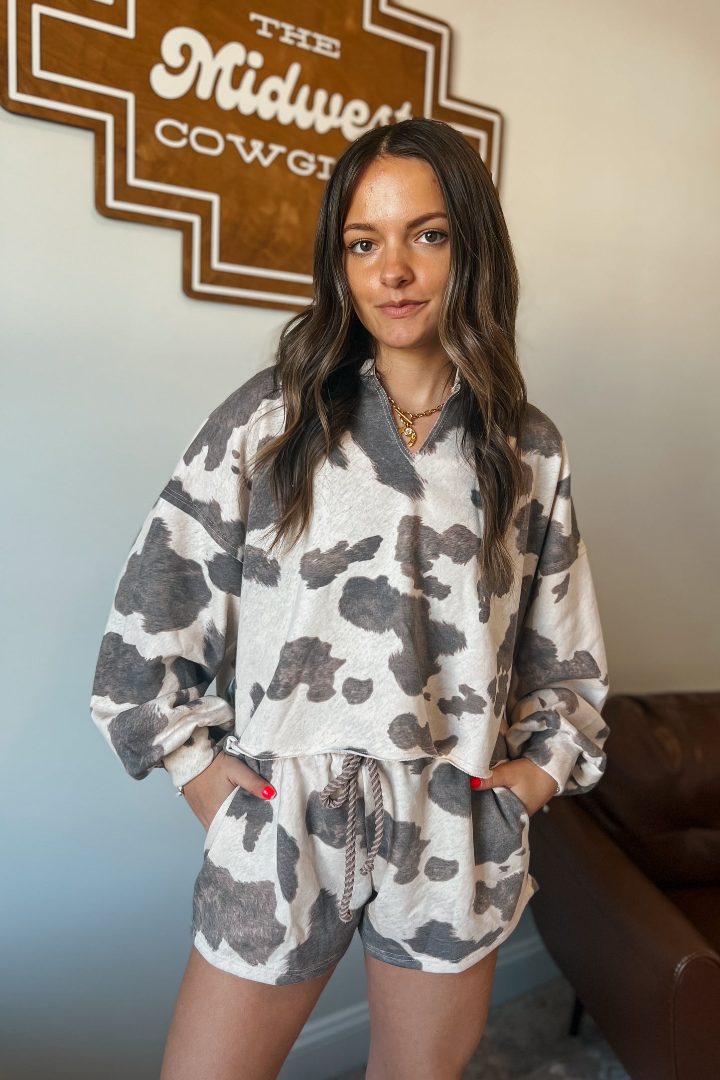 Gray and cream cow print lounge set featuring a long sleeve V-neck top and matching drawstring shorts