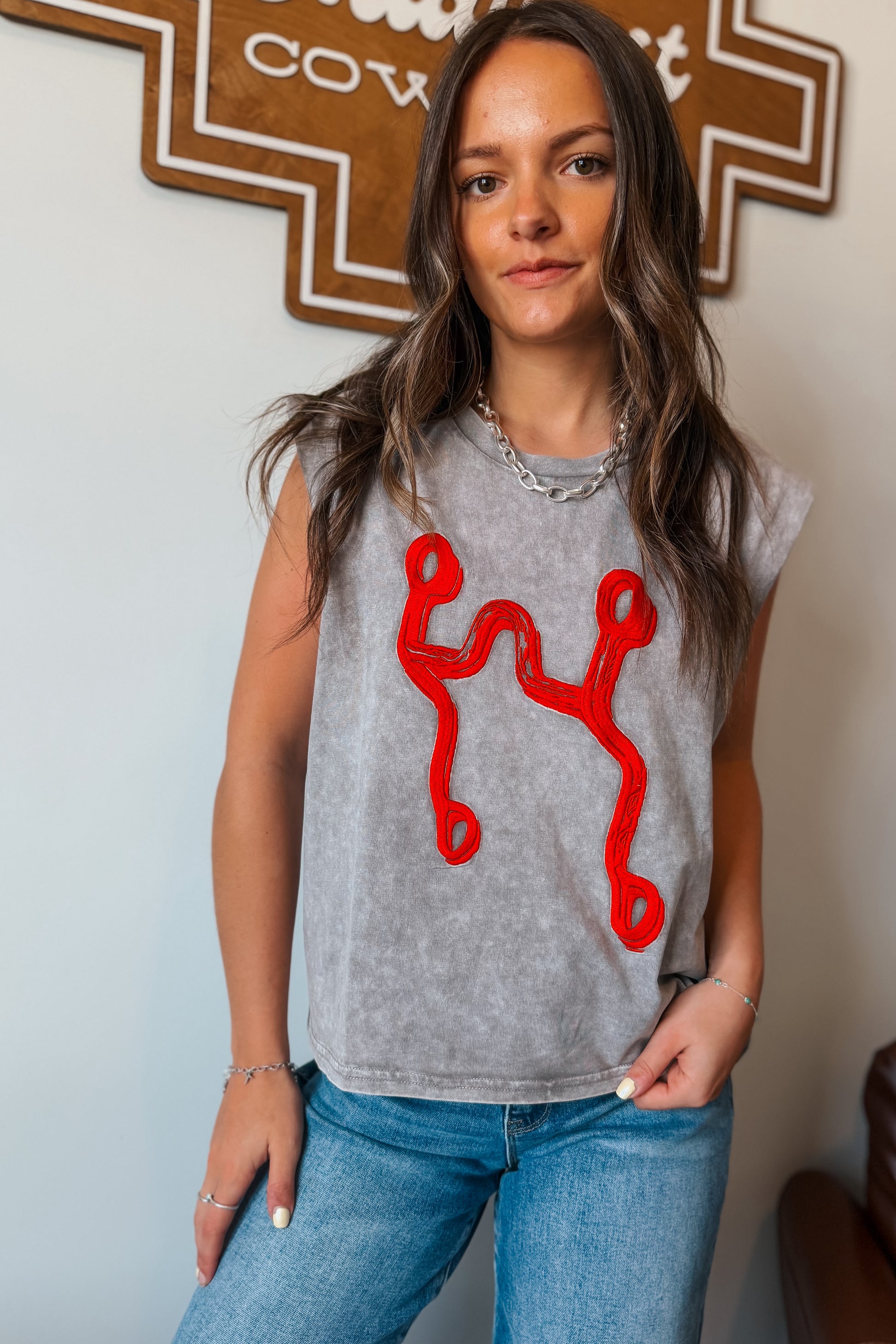 Gray mineral wash muscle tank top with red curb bit embroidery on the front.