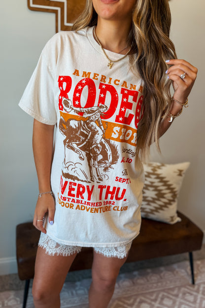 Cream oversized graphic tee featuring an American rodeo-inspired design on the front.