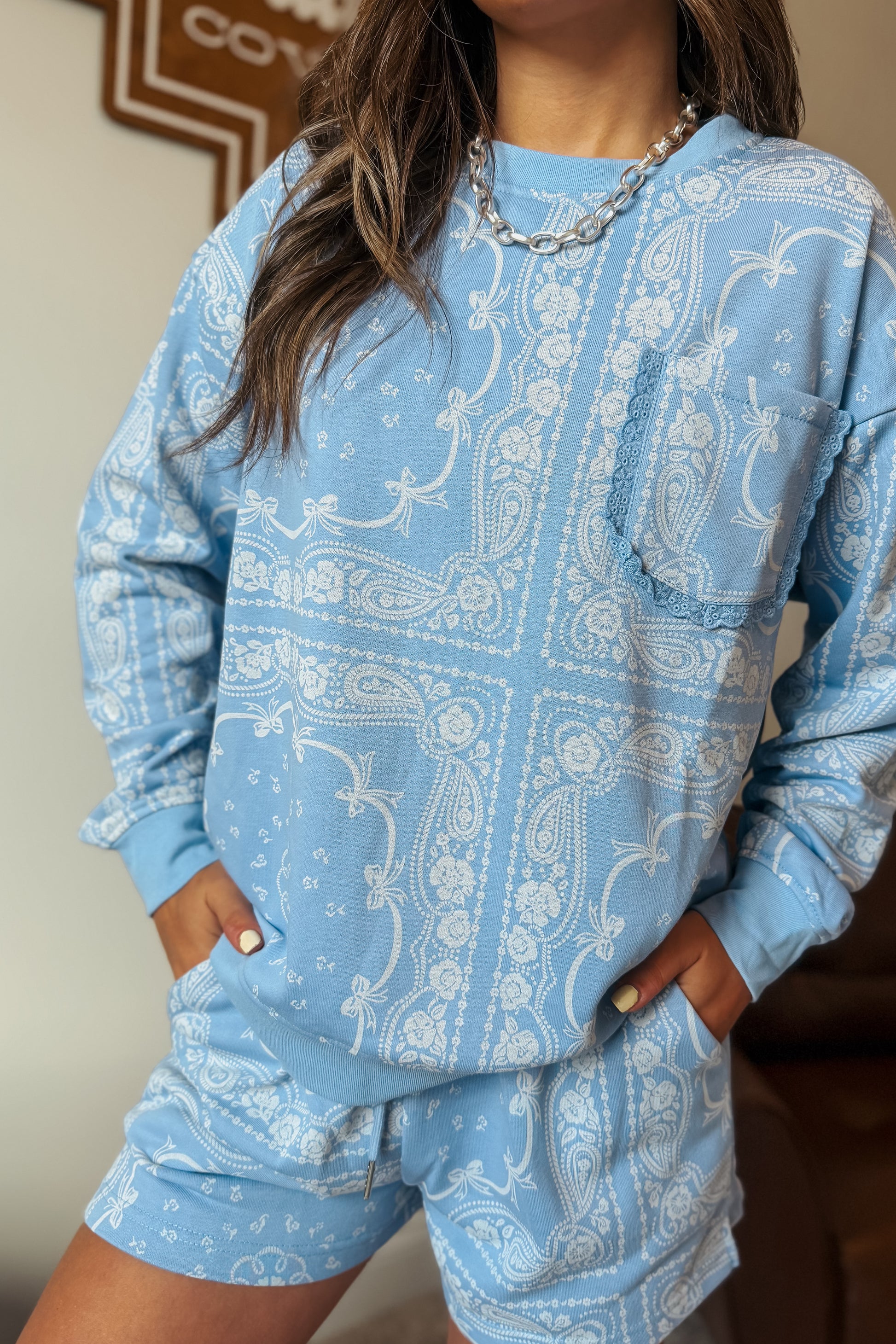 Periwinkle bandana print lounge set with bows, lace trim, and pocket sweatshirt.