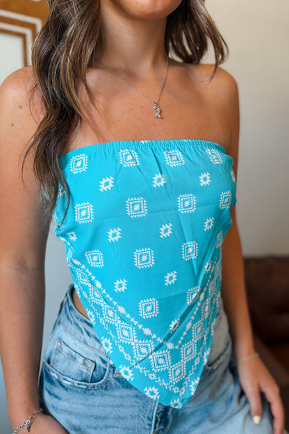 Vibrant turquoise strapless tube top with bandanna print, front styled in a V shape.