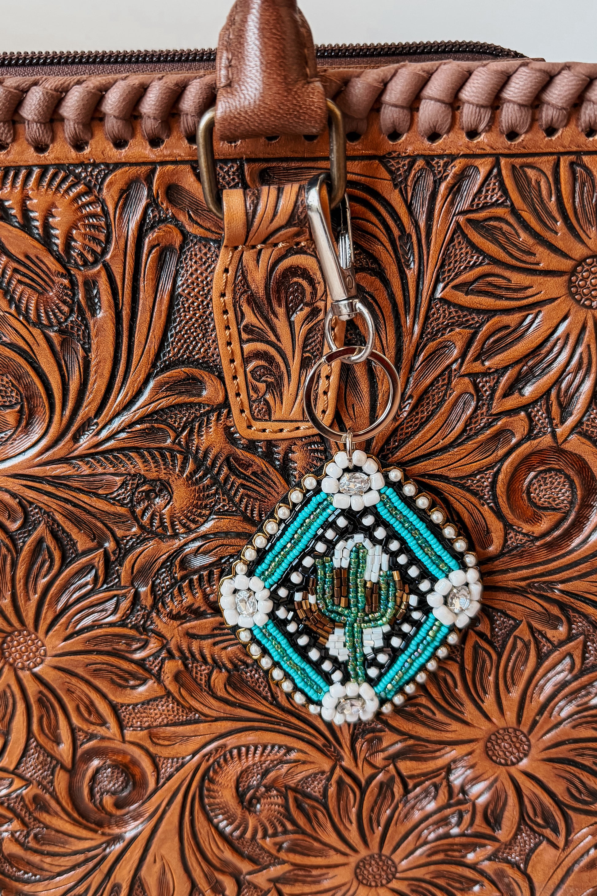 Green beaded cactus keychain with decorative bead details, designed to attach to keys or a bag.