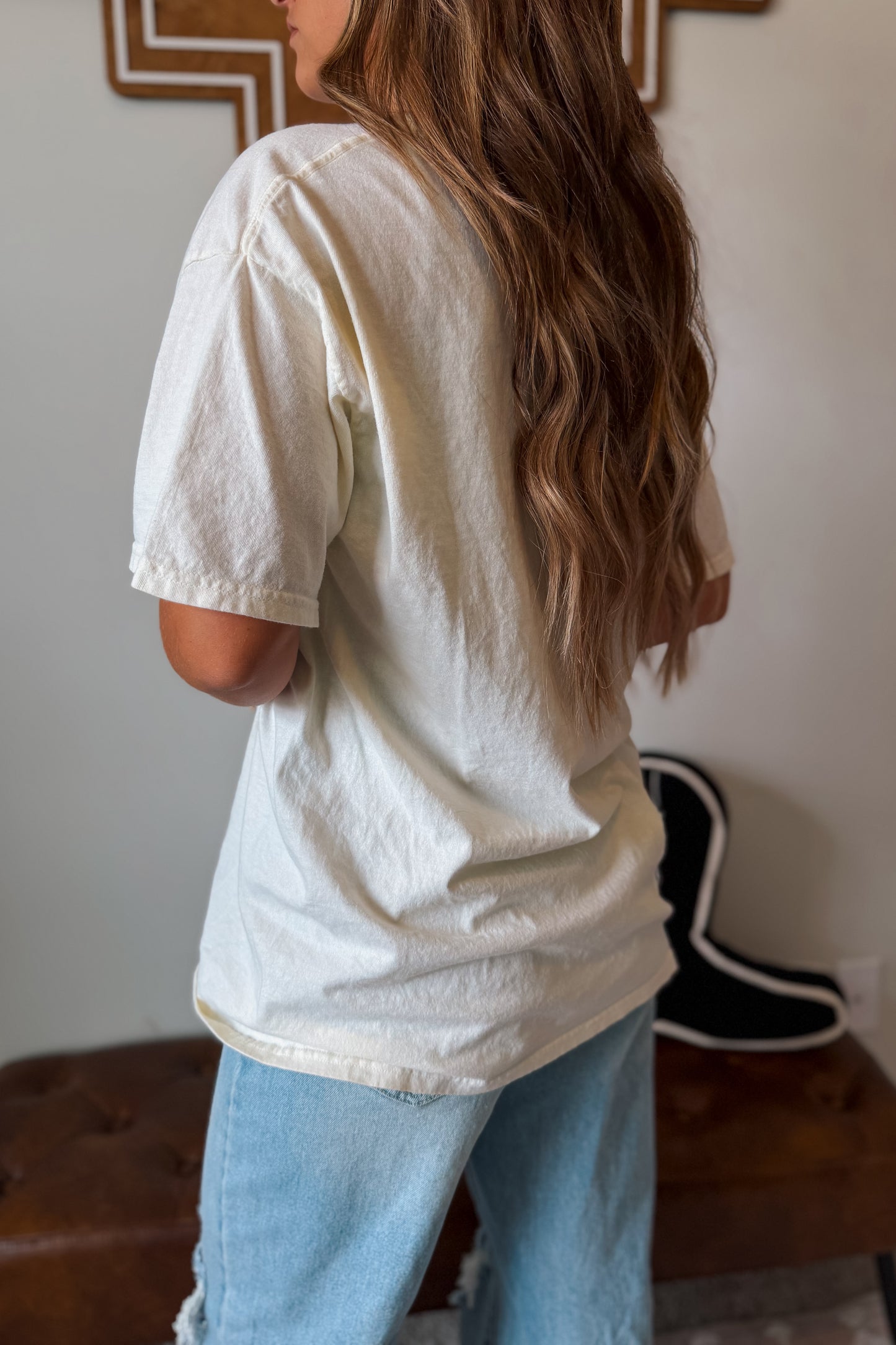 Back view of white Wild West graphic tee with relaxed fit.

