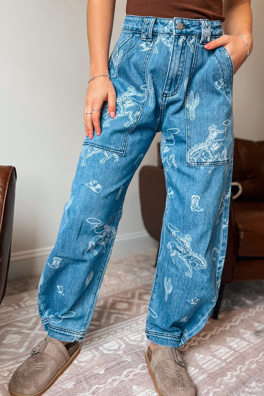 Model wearing western-inspired printed denim jeans with relaxed barrel-leg fit
