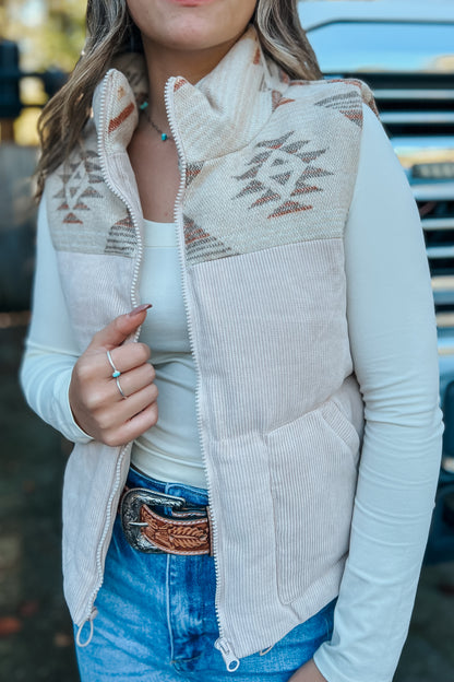 Model wearing Aztec graphic corduroy puffer vest with mock neck