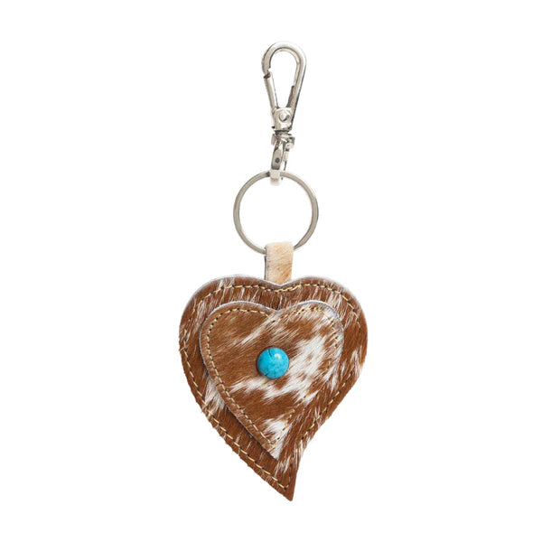Heart-shaped cowhide keychain with natural brown and white pattern.