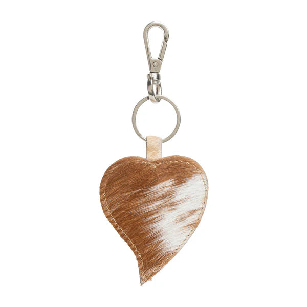 Heart-shaped cowhide keychain with natural brown and white pattern.
