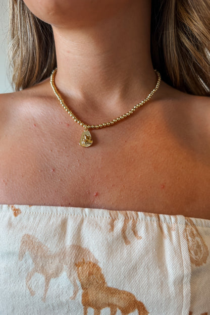Gold cowboy hat charm necklace with a polished Western-style hat pendant on a delicate gold chain