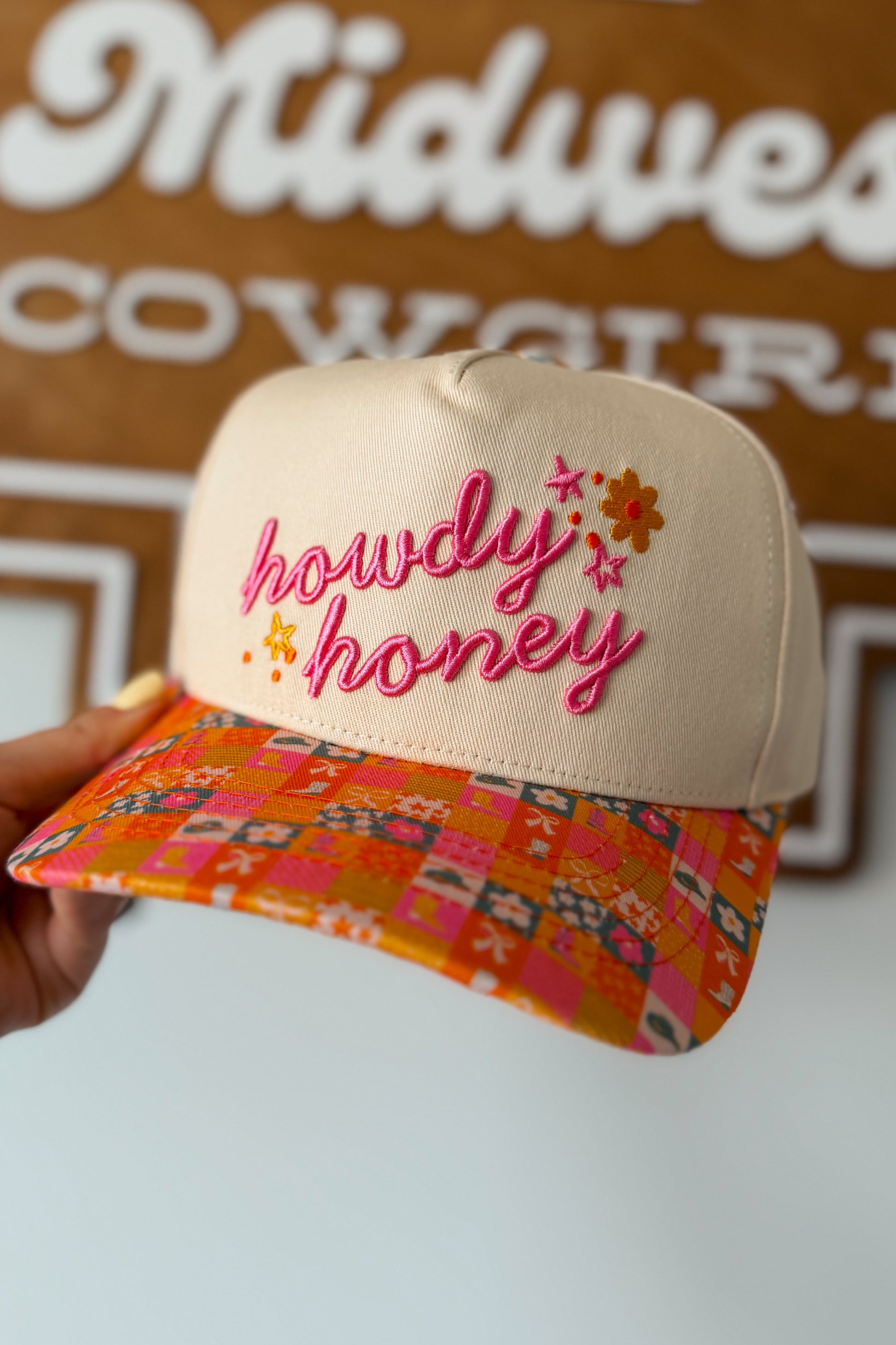 Pink and orange canvas cap with ‘Howdy Honey’ text on the front and a checkered pattern on the brim, casual Western-inspired accessory