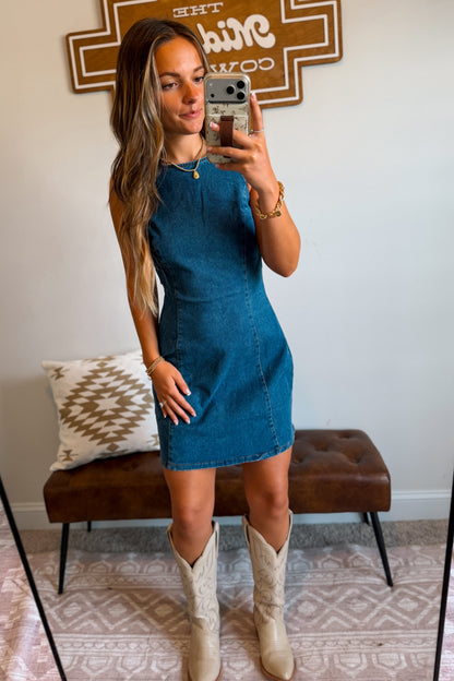     Women’s denim mini dress in a classic blue wash with a structured fit and above-the-knee length.