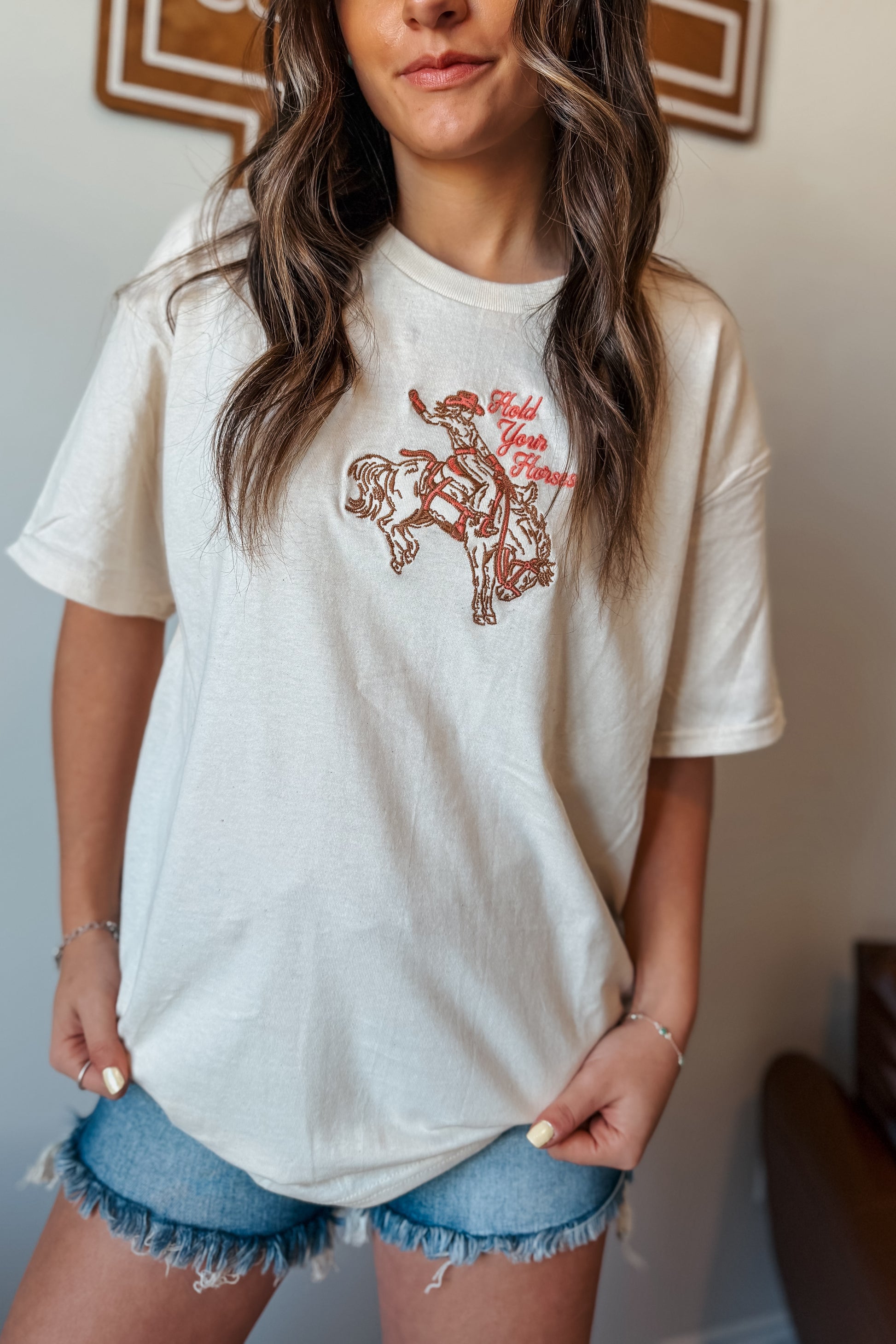 Cream oversized t-shirt with ‘Hold Your Horses’ embroidered in pink on the front