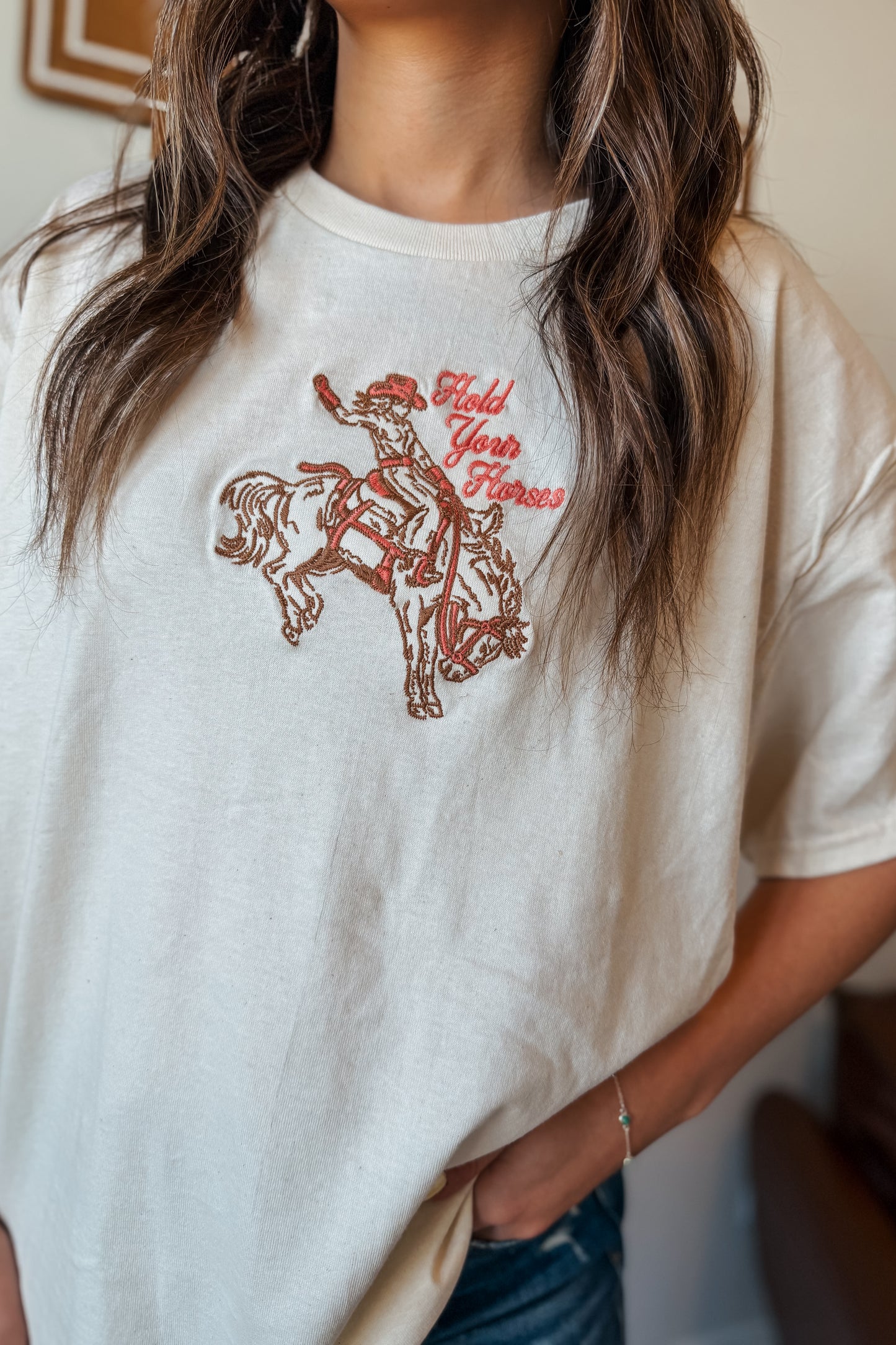 Cream oversized t-shirt with ‘Hold Your Horses’ embroidered in pink on the front