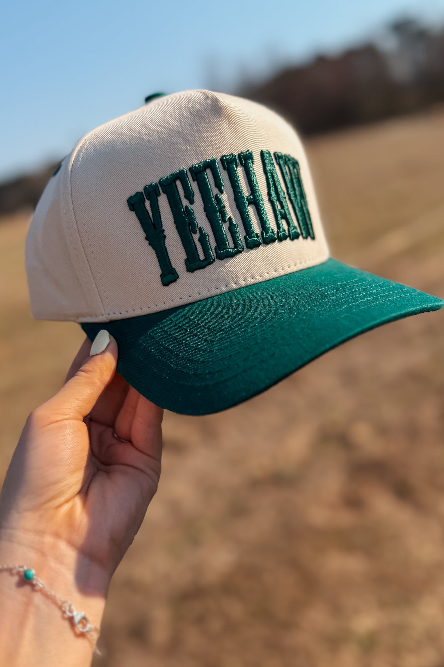 Beige and green cap with 'YEEHAW' text