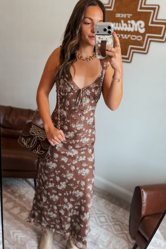 Front view of brown floral midi dress with ruffle tank-style spaghetti straps.