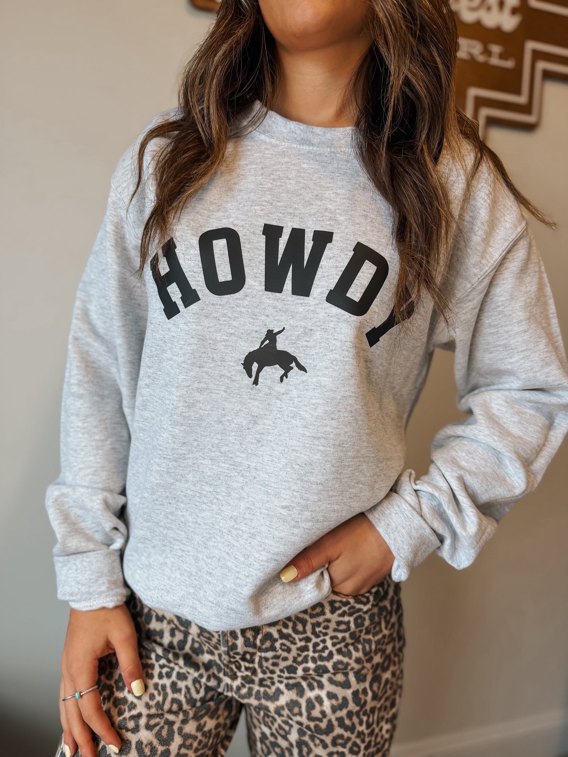 Model wearing Ash grey Crewneck with Howdy text on the front in black