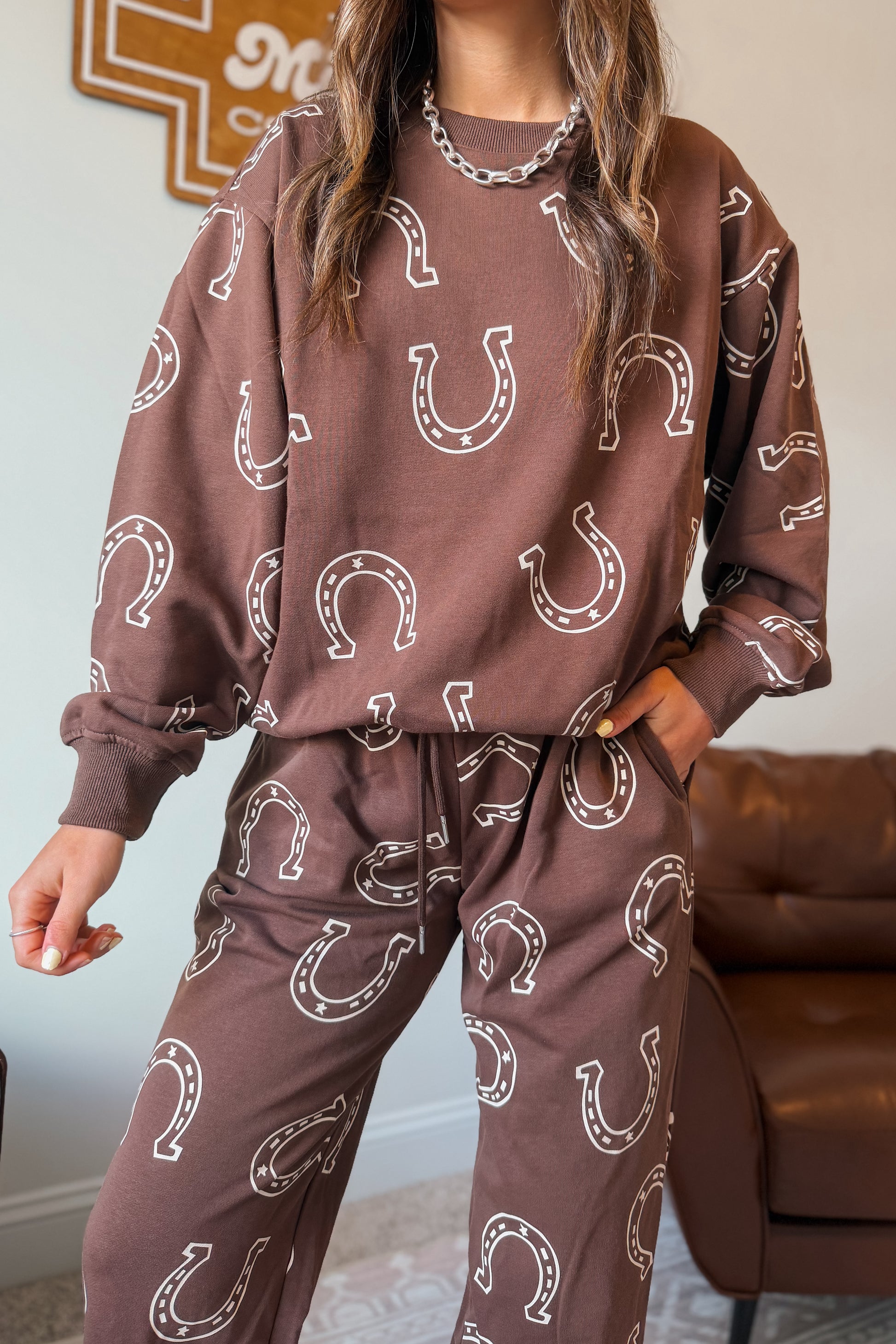 Brown sweatshirt and jogger pants set with white horseshoe print.
