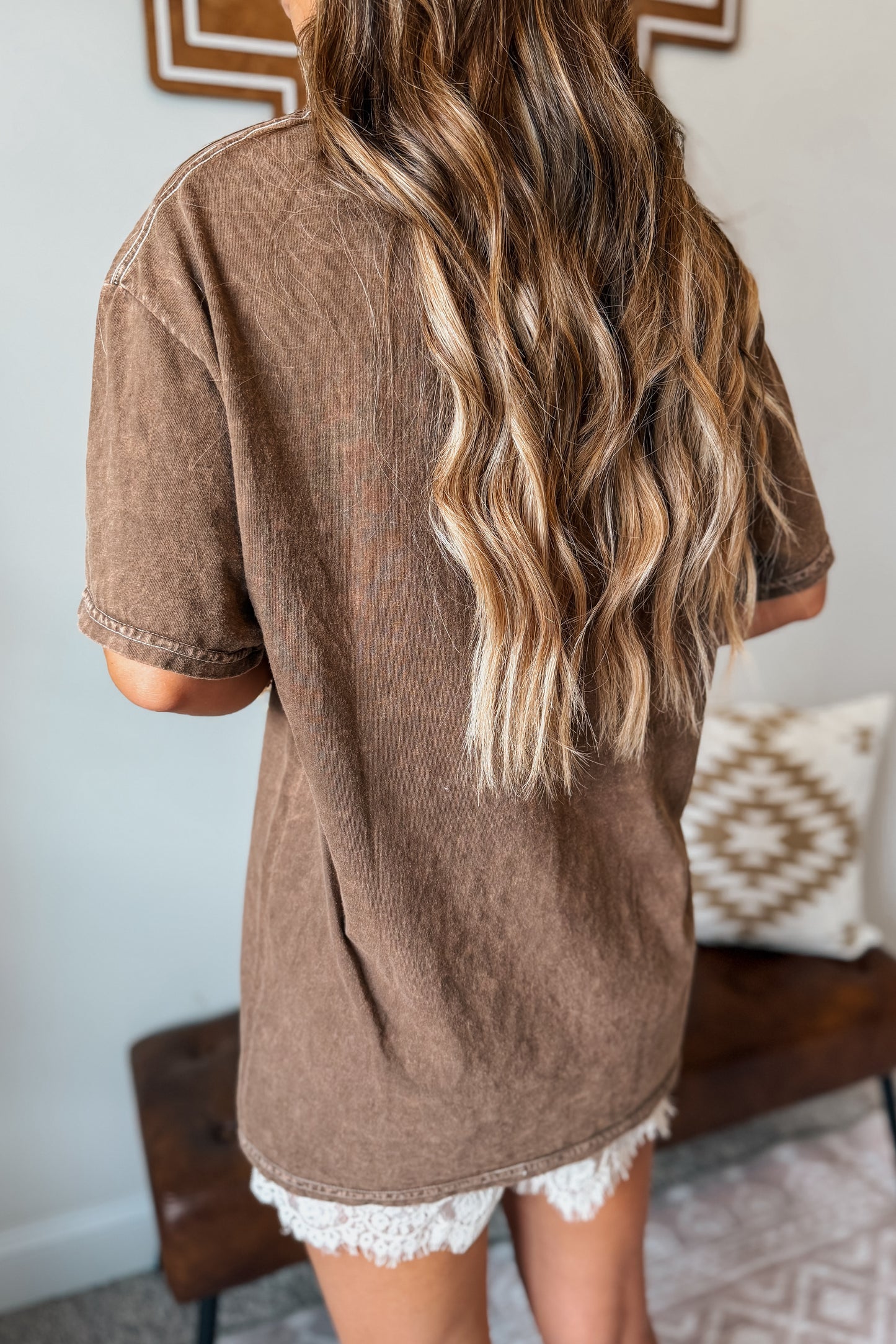Back view of a brown graphic tee with a classic casual silhouette.