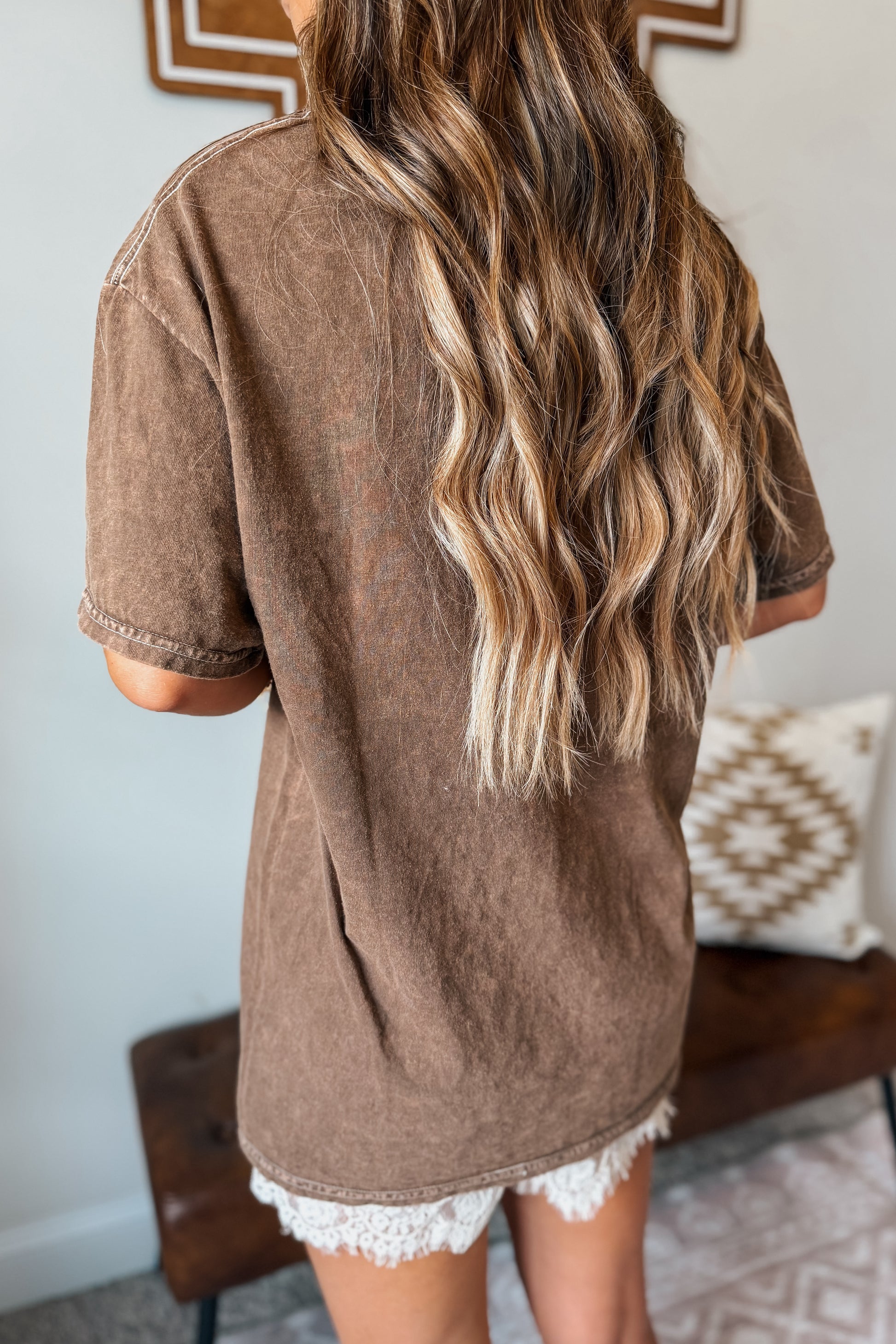 Back view of a brown graphic tee with a classic casual silhouette.