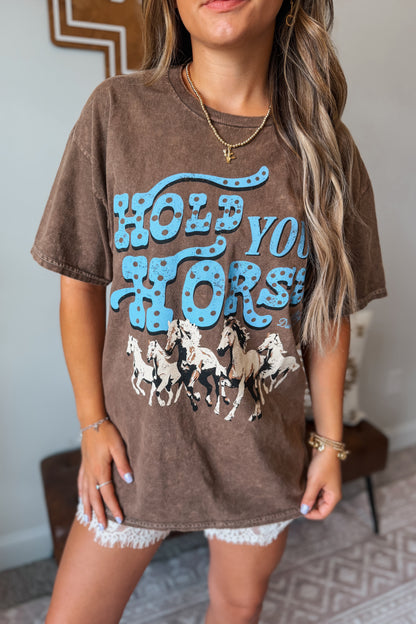 Brown graphic tee featuring a "Hold Your Horses" design on the front