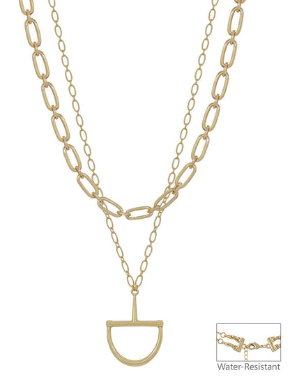 Gold chain necklace with a unique pendant on a white background