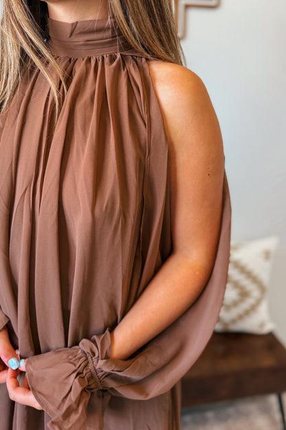 Close-up of the brown halter neckline and fabric details.