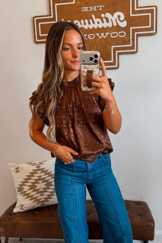Brown leopard print top featuring layered ruffle sleeves and a relaxed silhouette. Designed with an allover leopard pattern for a bold western-inspired look.
