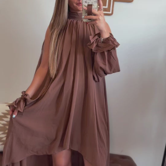Video showing the fit, movement, halter neckline, and flowy high-low hemline of the brown maxi dress.
