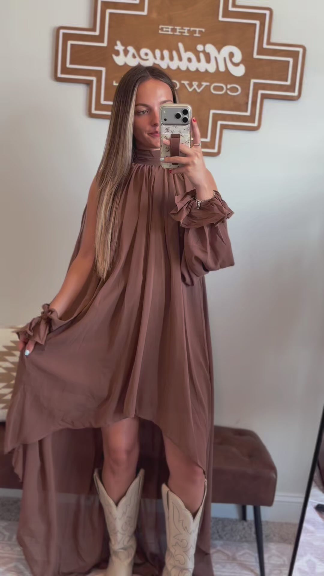 Video showing the fit, movement, halter neckline, and flowy high-low hemline of the brown maxi dress.
